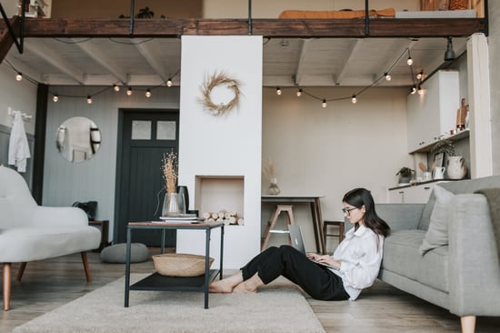 Women sitting on floor looking at laptop