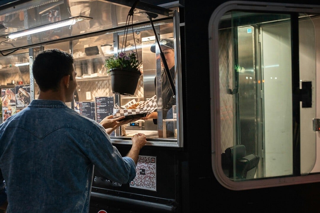 Pexels_woman serves man from food truck