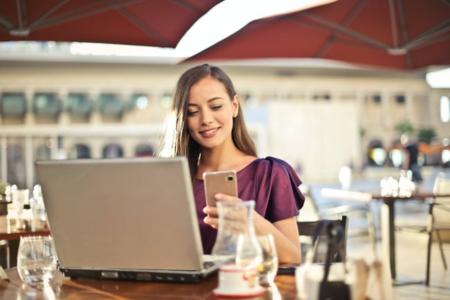 Woman on phone with laptop_Eftpos NZ